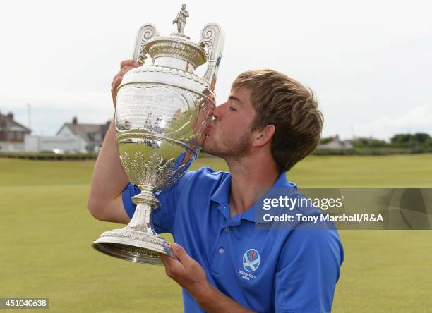 Bradley Neil of Blairgowrie with the trophy after winning the final round of The Amateur Championship 2014 Day Seven at Royal Portrush Golf Club on...
