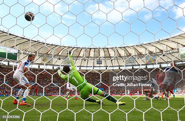 Divock Origi of Belgium scores his team's first goal past Igor Akinfeev of Russia during the 2014 FIFA World Cup Brazil Group H match between Belgium...
