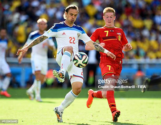 Andrey Yeshchenko of Russia and Kevin De Bruyne of Belgium compete for the ball during the 2014 FIFA World Cup Brazil Group H match between Belgium...