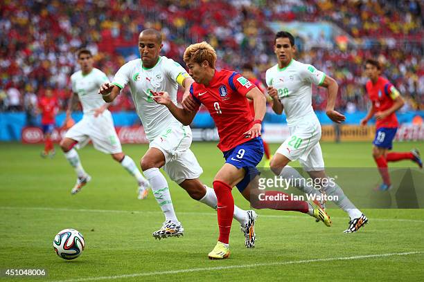Son Heung-Min of South Korea controls the ball against Madjid Bougherra of Algeria during the 2014 FIFA World Cup Brazil Group H match between South...