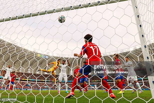 Rafik Halliche of Algeria scores his team's second goal on a header past goalkeeper Jung Sung-Ryong and Lee Chung-Yong of South Korea during the 2014...
