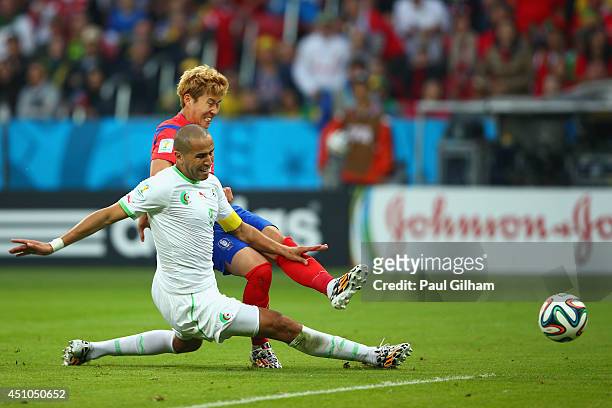 Son Heung-Min of South Korea scores his team's first goal past Madjid Bougherra of Algeria during the 2014 FIFA World Cup Brazil Group H match...