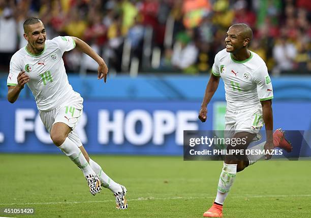 Algeria's midfielder Yacine Brahimi celebrates scoring with Algeria's midfielder Nabil Bentaleb during a Group H football match between South Korea...