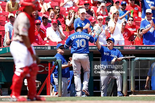 Edwin Encarnacion of the Toronto Blue Jays returns to the dugout after hitting a solo home run in the eighth inning of the game against the...
