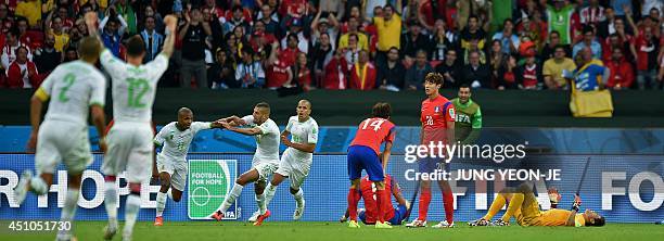 Algeria's midfielder Yacine Brahimi celebrates scoring with teammates as South Korea's midfielder Han Kook-Young, South Korea's defender Hong...