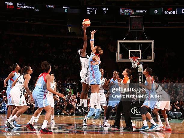 Tina Charles of the New York Liberty goes up for a jump ball against Erika de Souza of the Atlanta Dream during a game at Madison Square Garden in...