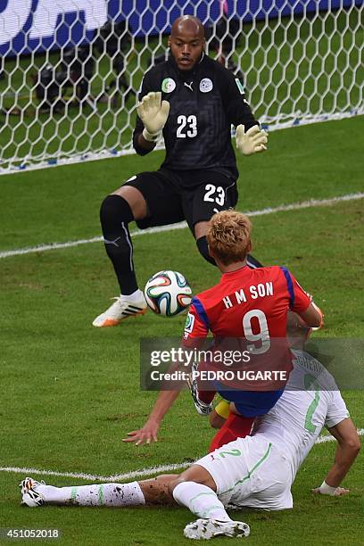Algeria's goalkeeper Rais Mbohli fails to stop the ball as South Korea's midfielder Son Heung-Min scores his team's first goal during the Group H...