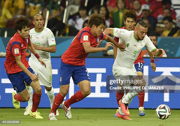 South Korea's defender Hong Jeong-Ho fights for the ball with Algeria's forward Nabil Ghilas during a Group H football match between South Korea and...