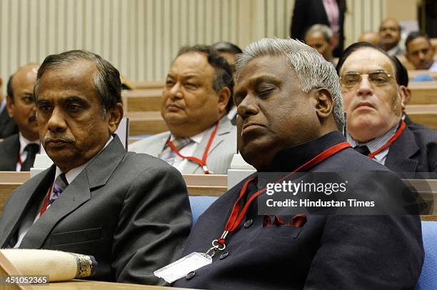 Director Ranjit Sinha takes a nap and other DGPs looks on during the Home Minister giving speech at the All India Conference of DGPs/IGPs at Vigyan...