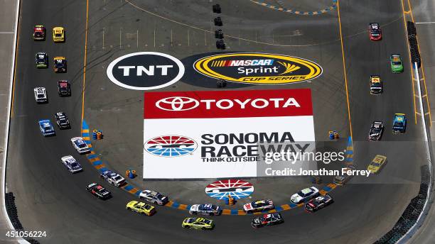 Clint Bowyer, driver of the 5-hour ENERGY Toyota, leads Joey Logano, driver of the Shell-Pennzoil Ford, on a restart during the NASCAR Sprint Cup...
