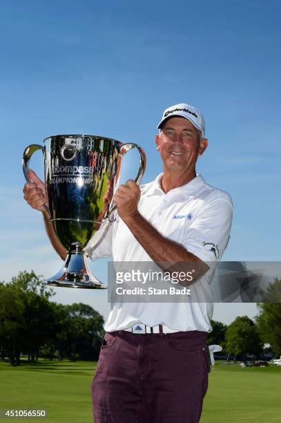 Tom Lehman poses with the winner's trophy on the 18th green during the final round of the Champions Tour's Encompass Championship at North Shore...