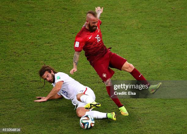 Kyle Beckerman of the United States tackles Raul Meireles of Portugal during the 2014 FIFA World Cup Brazil Group G match between the United States...