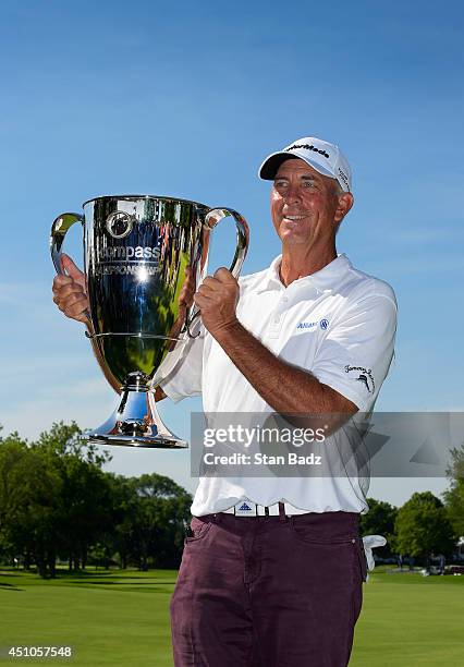 Tom Lehman poses with the winner's trophy on the 18th green during the final round of the Champions Tour's Encompass Championship at North Shore...