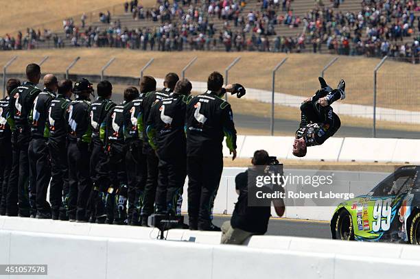 Carl Edwards, driver of the Aflac Ford, celebrates with a backflip after winning the NASCAR Sprint Cup Series Toyota/Save Mart 350 at Sonoma Raceway...