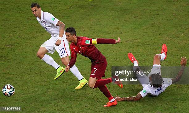 Cristiano Ronaldo of Portugal controls the ball against Geoff Cameron and Jermaine Jones of the United States during the 2014 FIFA World Cup Brazil...