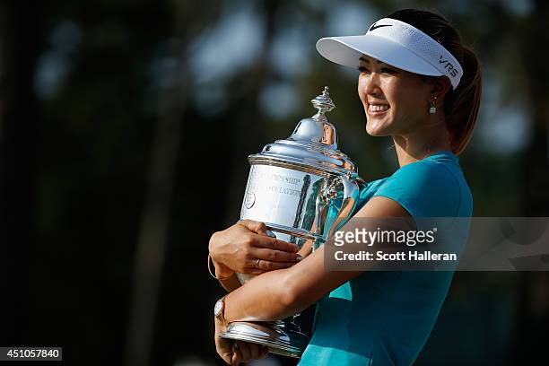 Michelle Wie of the United States poses with the trophy after her two-stroke victory at the 69th U.S. Women's Open at Pinehurst Resort & Country...