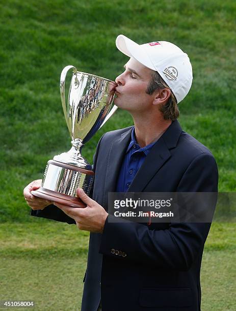 Kevin Streelman of the United States kisses the trophy after winning the Travelers Championship golf tournament at the TPC River Highlands on June...