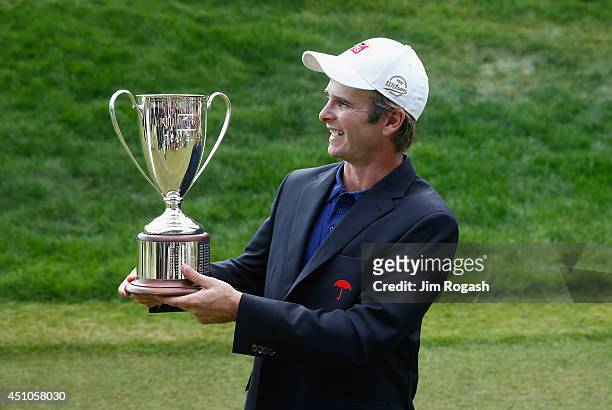 Kevin Streelman of the United States holds the trophy after winning the Travelers Championship golf tournament at the TPC River Highlands on June 22,...