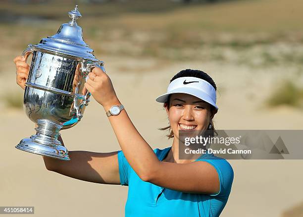 Michelle Wie of the USA proudly holds the trophy after her victory during the final round of the 69th U.S. Women's Open at Pinehurst Resort & Country...