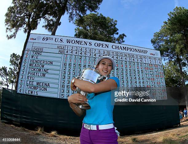 Michelle Wie of the USA proudly holds the trophy after her victory during the final round of the 69th U.S. Women's Open at Pinehurst Resort & Country...