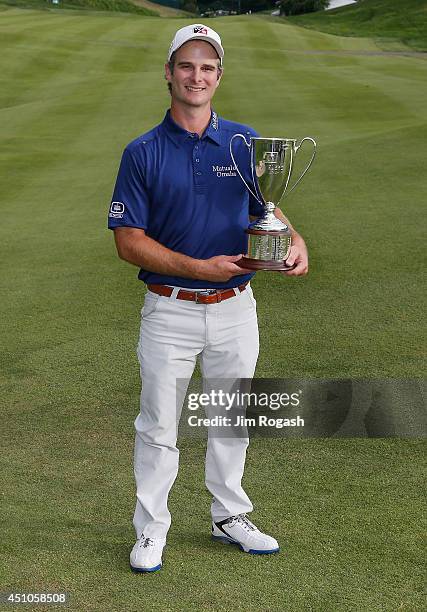 Kevin Streelman of the United States holds the trophy after winning the Travelers Championship golf tournament at the TPC River Highlands on June 22,...