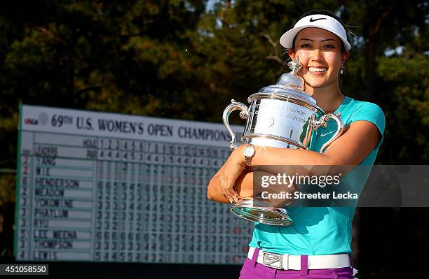 Michelle Wie of the United States celebrates with the trophy after winning in the final round of the 69th U.S. Women's Open at Pinehurst Resort &...