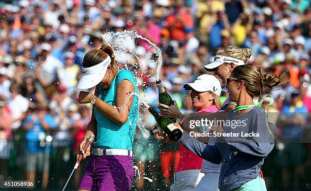 Michelle Wie of the United States is sprayed with champagne by Jamie Kuhn, Jessica Korda and Jaye Marie Green after the final round of the 69th U.S....