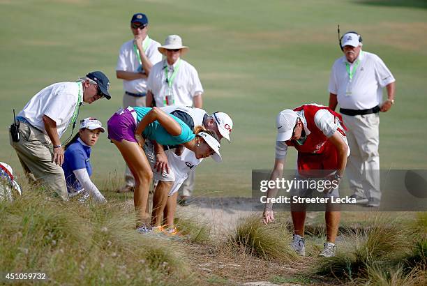 Michelle Wie of the United States looks for her ball on the16th hole during the final round of the 69th U.S. Women's Open at Pinehurst Resort &...