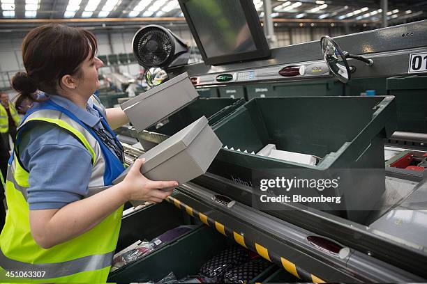 An employee processes customers' orders inside the John Lewis Plc semi-automated distribution centre in Milton Keynes, U.K., on Thursday, Nov. 21,...