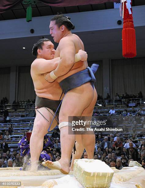 Mongolian yokozuna Hakuho , whose real name is Mnkhbatyn Davaajargal pushes Homasho to win during the day nine of the Grand Sumo Kyushu Tournament at...