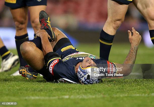 Johnathan Thurston of the Cowboys grimaces after getting injured during the round 15 NRL match between the Newcastle Knights and the North Queensland...