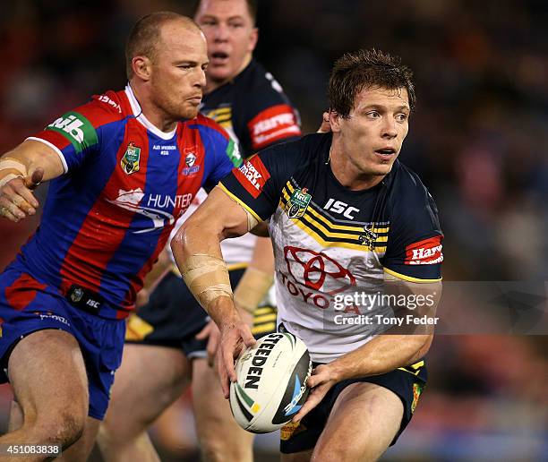 Rory Kostjasyn of the Cowboys looks to pass the ball during the round 15 NRL match between the Newcastle Knights and the North Queensland Cowboys at...