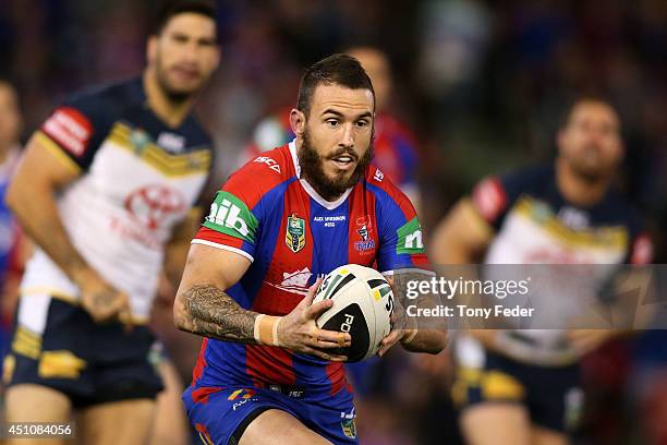 Darius Boyd of the Knights runs with the ball during the round 15 NRL match between the Newcastle Knights and the North Queensland Cowboys at Hunter...