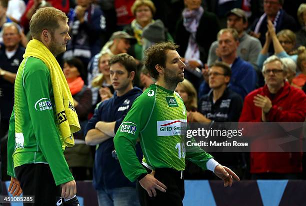 Johannes Bitter and team mate Marcus Cleverl of Hamburg look dejected after during the VELUX EHF Handball Champions League group D match between SG...