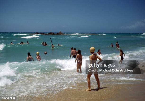 View as people wade in the surf on the beach in Beirut, Lebanon.