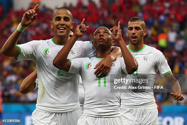 Yacine Brahimi of Algeria celebrates scoring his team's fourth goal with his teammates Madjid Bougherra and Islam Slimani during the 2014 FIFA World...