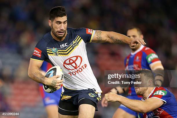 James Tamou of the Cowboys is tackled by the Knights defence during the round 15 NRL match between the Newcastle Knights and the North Queensland...