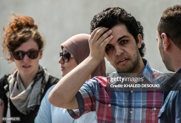 Newly freed Al-Jazeera news channel's journalist Abdullah Elshamy stands outside the court during the trial of three of his colleagues for allegedly...