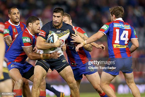 James Tamou of the Cowboys is tackled by Willie Mason of the Knights during the round 15 NRL match between the Newcastle Knights and the North...