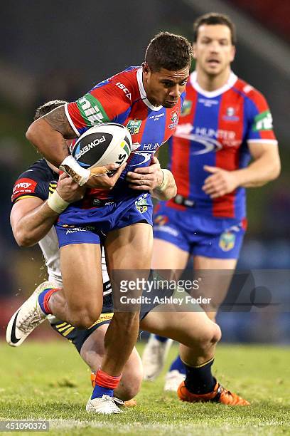 Dane Gagai of the Knights is tackled by the Cowboys defencel during the round 15 NRL match between the Newcastle Knights and the North Queensland...