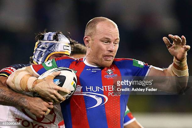 Beau Scott of the Knights is tackled by Johnathan Thurston of the Cowboys during the round 15 NRL match between the Newcastle Knights and the North...