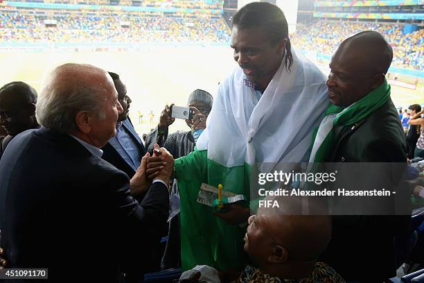 President Joseph S. Blatter talks to Nwankwo Kanu prior to the 2014 FIFA World Cup Group F match between Nigeria and Bosnia-Herzegovina at Arena...