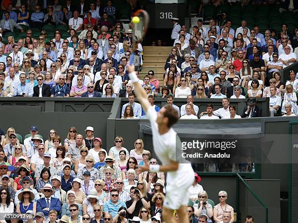 Andy Murray of Great Britain serves during his Gentlemen's Singles first round match against David Goffin of Belgium on day one of the Wimbledon Lawn...
