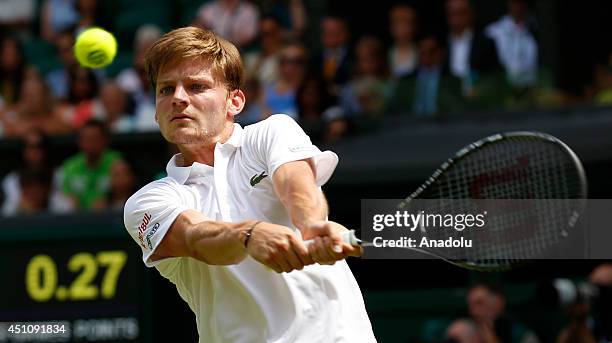 David Goffin of Belgium returns the ball during his Gentlemen's Singles first round match against Andy Murray of Great Britain during the Wimbledon...