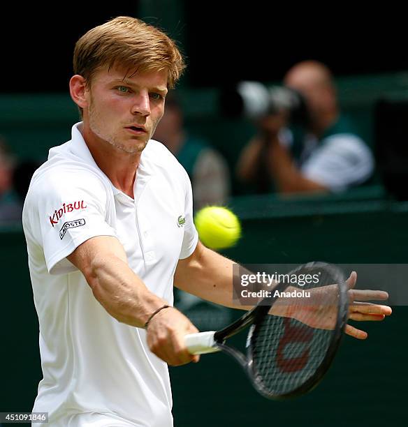 David Goffin of Belgium returns the ball during his Gentlemen's Singles first round match against Andy Murray of Great Britain during the Wimbledon...