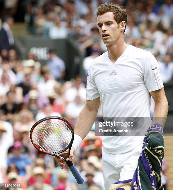 Andy Murray of Great Britain serves during his Gentlemen's Singles first round match against David Goffin of Belgium on day one of the Wimbledon Lawn...