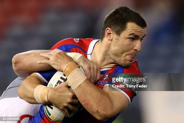 James McManus of the Knights is tackled during the round 15 NRL match between the Newcastle Knights and the North Queensland Cowboys at Hunter...