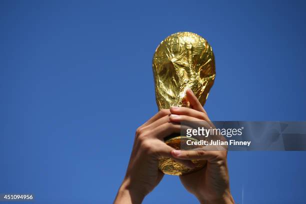 Fan holds up a replica of the World Cup trophy prior to the 2014 FIFA World Cup Brazil Group B match between the Netherlands and Chile at Arena de...