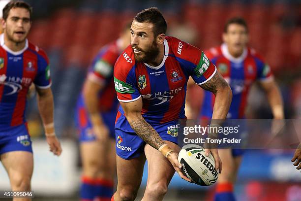 Darius Boyd of the Knights looks to pass the ball during the round 15 NRL match between the Newcastle Knights and the North Queensland Cowboys at...