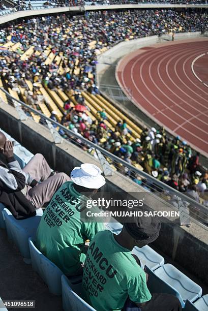 Striking South African platinum miner sit at the Royal Bafokeng stadium near the northwestern town of Rustenburg, some 200 km northwest of...